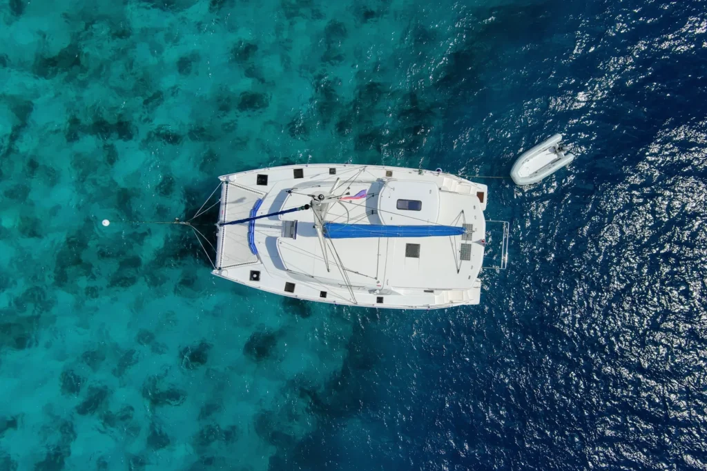 An aerial view of a catamaran during a Belize Sailing Vacation in the ocean.