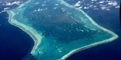 An aerial view of an island in Belize in the ocean.