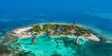 An aerial view of an island in Belize in the ocean.