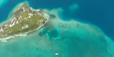 An aerial view of Belize, an island in the ocean.