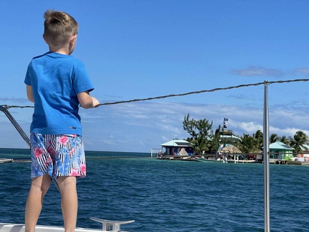 A young boy on a sailing vacation deck in Belize.