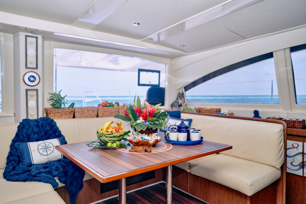 A luxury yacht with a table and chairs and a view of the ocean.