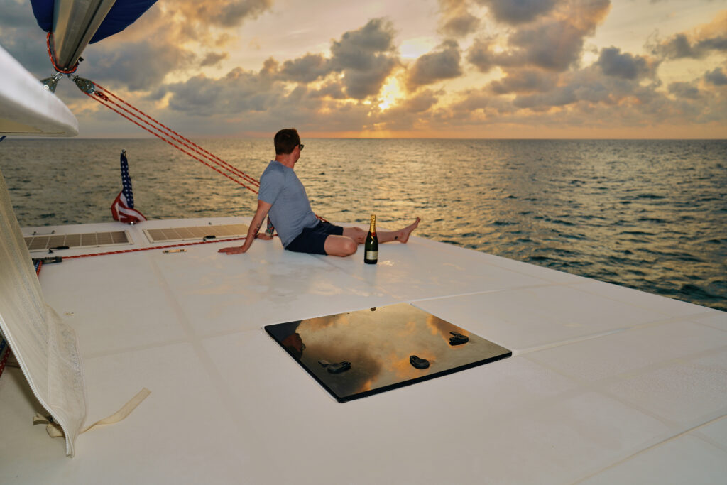 A man enjoying a peaceful moment on the deck of a Belize sailing boat.