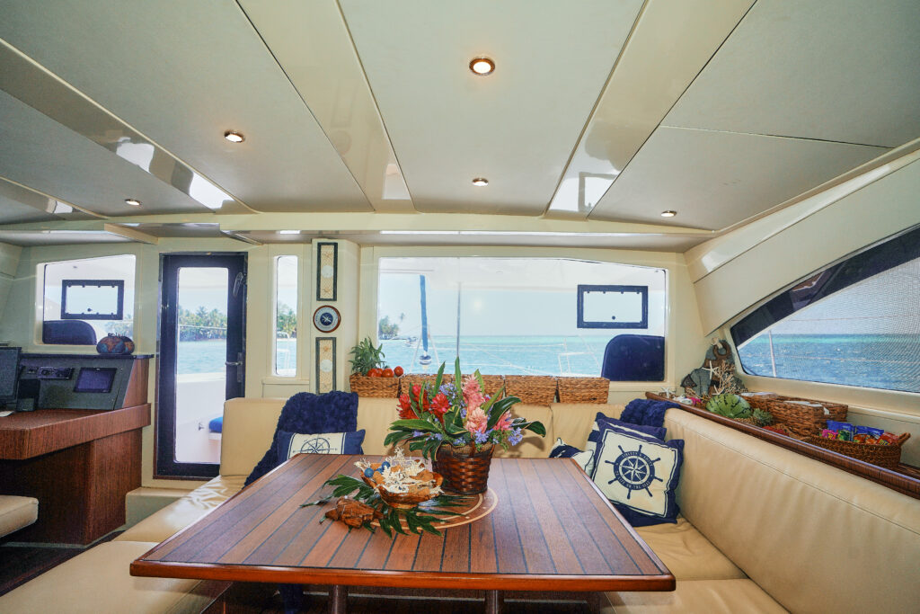 A boat with a dining table and couches.