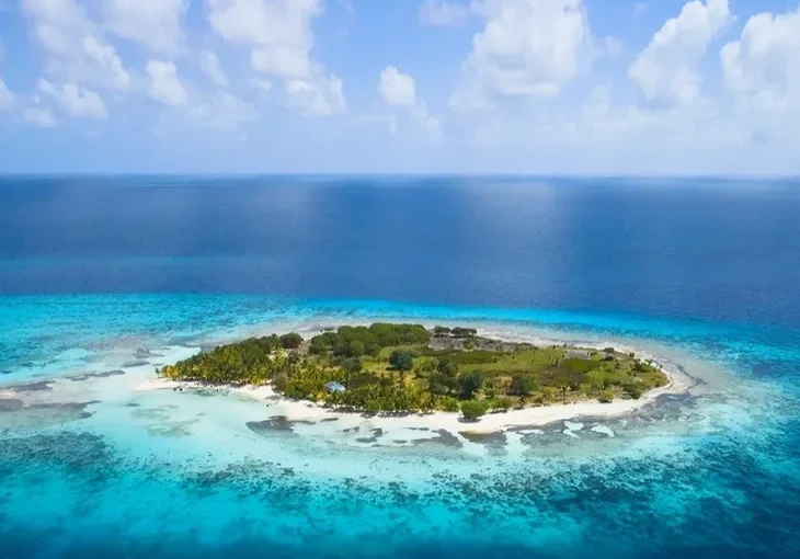 An aerial view of Belize, an island in the middle of the ocean, offering unforgettable sailing vacations and tours.